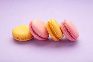 French colorful macarons on purple background