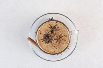 A cup of aroma tasty coffee with cinnamon sticks and star anise