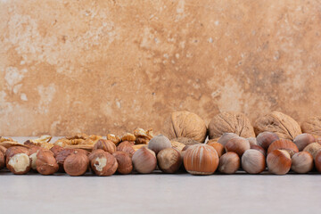 Mixed healthy nuts on marble background