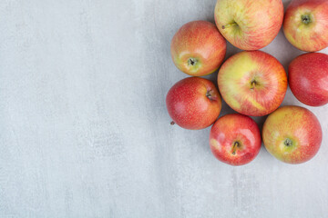Bunch of fresh apples on stone background