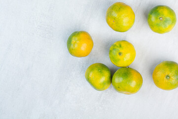 Bunch of fresh mandarines on stone background