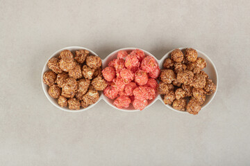 Appetizer platter with assorted popcorn candy on marble background
