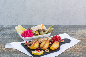 Delicious fish with salty vegetables and fried potatoes