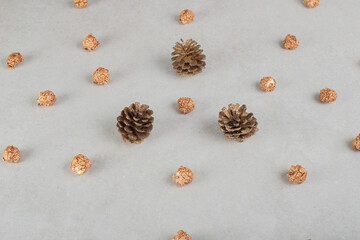Conifer cones and bits of candied popcorn all over the marble background