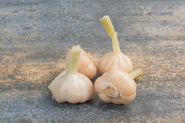 Salty delicious garlics on marble background