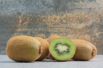 Ripe kiwi fruits on stone table