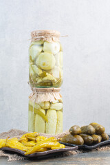 Pickled cucumbers with salty peppers on sackcloth