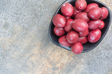 A dark plate of delicious fruits on white background