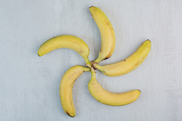 Bunch of yellow bananas on stone background