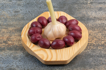 A whole salty garlic on wooden board