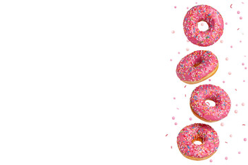 Four sweet donuts with pink icing are flying in the air. Isolated on white background. Copy space