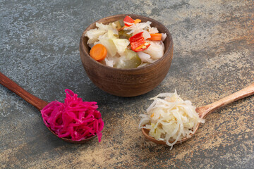 Two spoons of cabbages on marble background