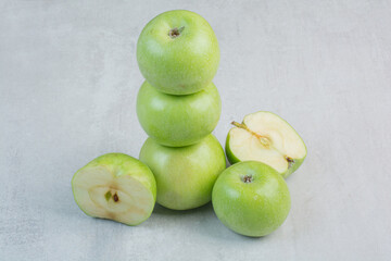Bunch of green apples on stone background
