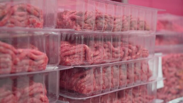 Raw minced meat in packages in a hypermarket close-up. Selective focus