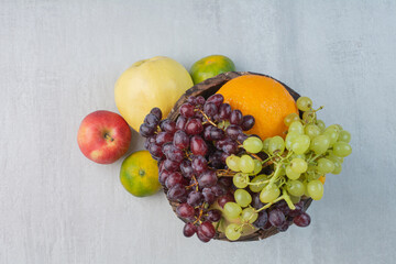 Bunch of various fruits in wooden bucket