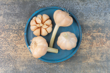 Salty delicious garlics on blue plate