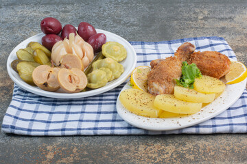 A white plate full of salty vegetables on tablecloth