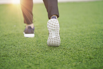 woman run on grass with shoes selective focus