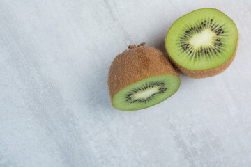 Half cut kiwi fruit on stone background