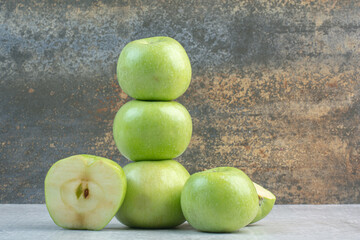 Bunch of green apples on stone background