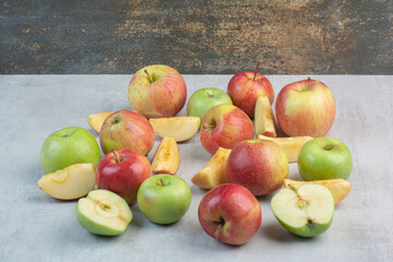 Bunch of red and green apples on stone table