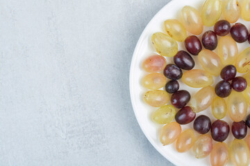 Fresh grapes plate on stone background