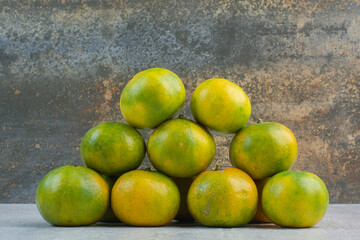 Bunch of fresh mandarines on stone background