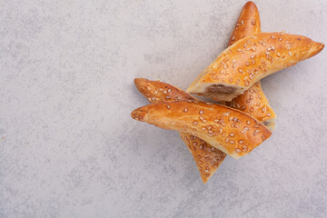 Half cut homemade biscuits on gray background