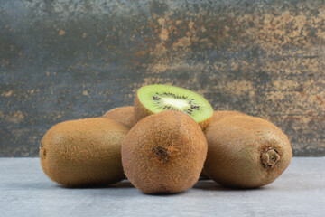 Ripe kiwi fruits on stone table