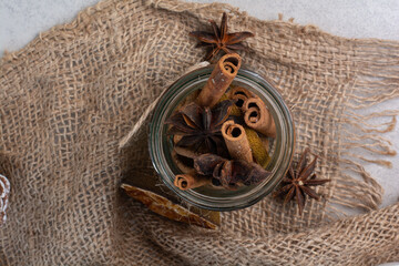 Cinnamon sticks in glass jar with burlap