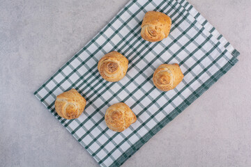 Tasty cookies with sesame seeds on tablecloth