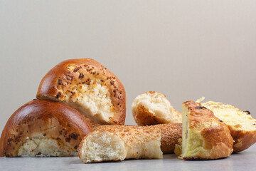 Half cut raisin buns and sesame bagels on beige background