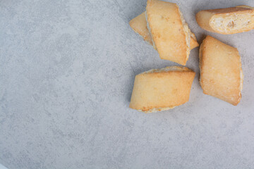 Tasty stuffed biscuits on gray table