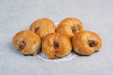Sweet biscuits with walnut kernels on gray background