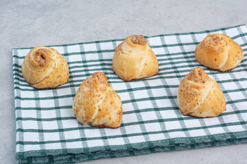 Tasty cookies with sesame seeds on tablecloth