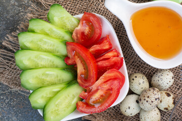 Vegetable bowl, quail eggs and honey on burlap