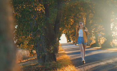Woman tourist with backpack walking in the countryside.