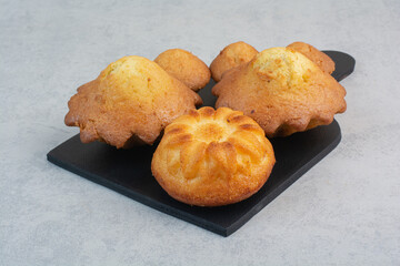 Sweet delicious pastries on dark board