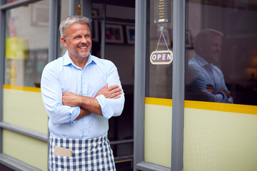 Portrait Of Male Owner Or Staff Standing Outside Coffee Shop