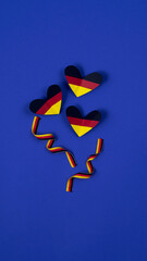 German style abstract background, hearts and ribbon in the colors of the German flag