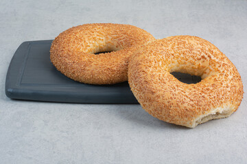 Two fresh delicious bagels on dark plate