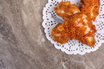 Fried chicken nuggets on marble background
