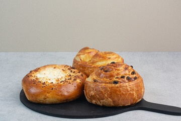 Sweet delicious pastries on dark board