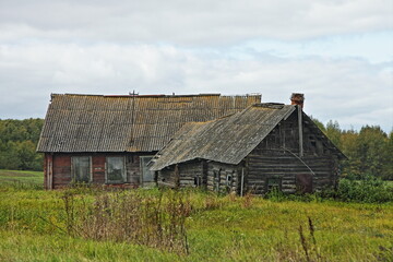 Fototapeta na wymiar Old abandoned farm house with barn