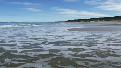 Vertical footage of the ocean washing the coasts of Dunedin, South Island, New Zealand