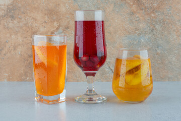 Various fruit lemonades on blue table