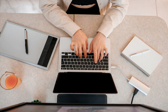 Close up of female designer works in home office drawing on graphic tablet. Freelancer working on project, watching movie on computer, studying, blogging, relaxing and chatting online