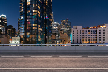 Obraz premium Empty urban asphalt road exterior with city buildings background. New modern highway concrete construction. Concept of way to success. Transportation logistic industry fast delivery. Los Angeles. USA.
