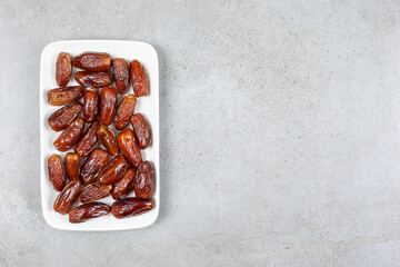 A platter of appetizing dates on marble background