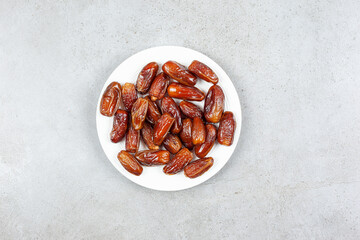 A platter of fresh dates on marble background